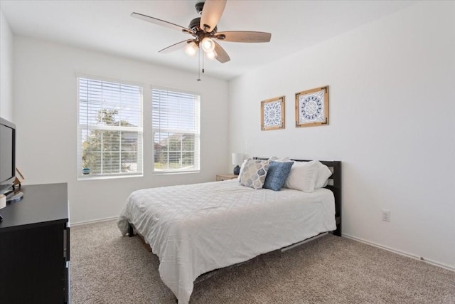 bedroom with ceiling fan and light carpet