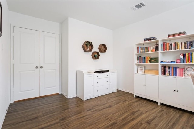 unfurnished bedroom featuring dark hardwood / wood-style floors and a closet