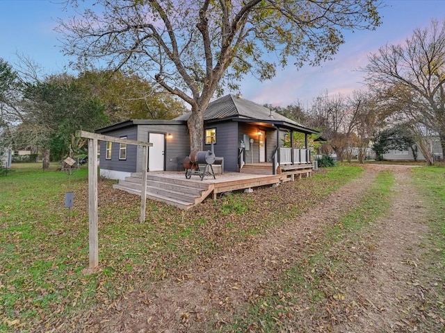 rear view of property with a yard and a deck