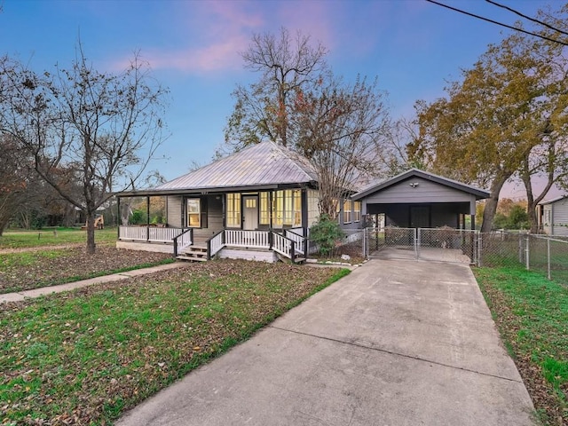 bungalow-style home featuring a front yard, covered porch, fence, a gate, and driveway