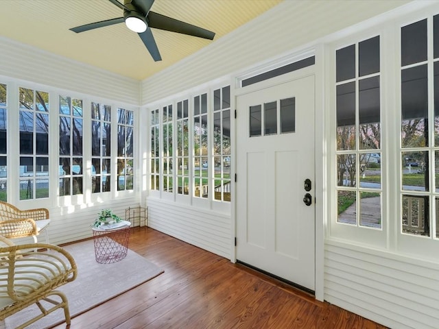 unfurnished sunroom featuring ceiling fan and a healthy amount of sunlight