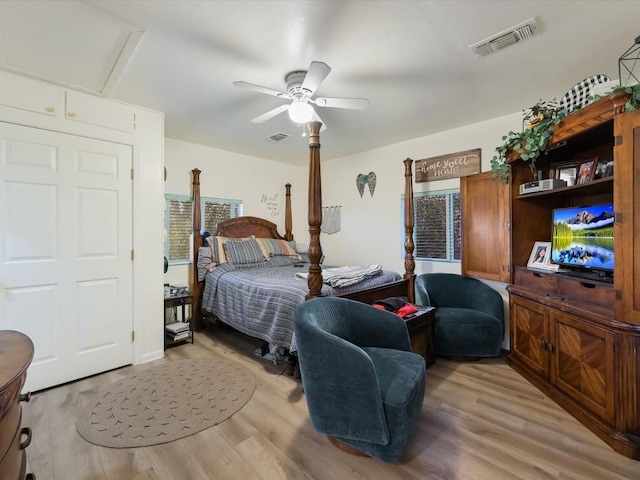 bedroom with visible vents, a ceiling fan, and wood finished floors