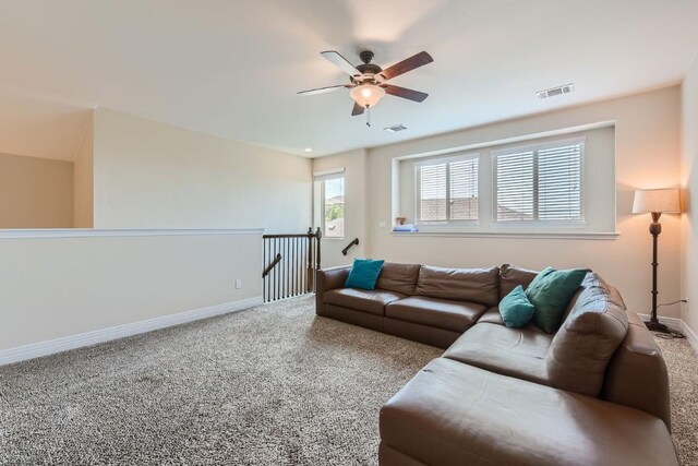 carpeted living room featuring ceiling fan