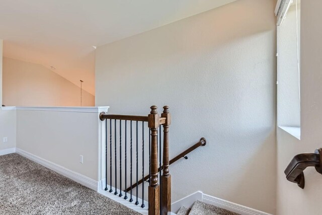 staircase with carpet and lofted ceiling