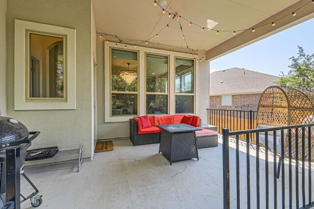 view of patio featuring grilling area and an outdoor living space with a fire pit