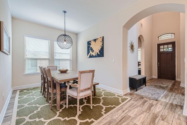 dining space with a notable chandelier and light wood-type flooring