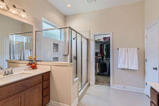 bathroom featuring tile patterned floors, vanity, and walk in shower