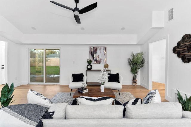 living room featuring ceiling fan and light hardwood / wood-style flooring