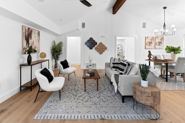 living room with light hardwood / wood-style floors, beam ceiling, high vaulted ceiling, and an inviting chandelier