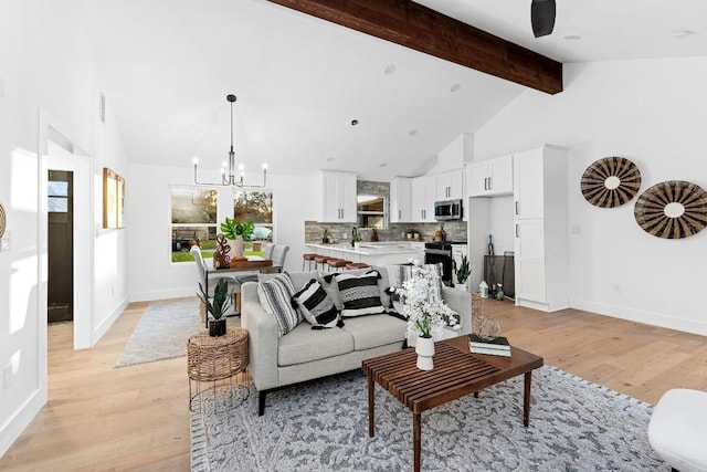 living room featuring beamed ceiling, a notable chandelier, light hardwood / wood-style floors, and high vaulted ceiling