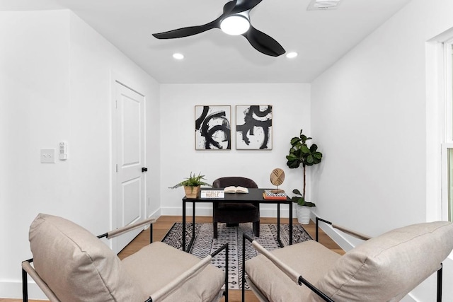 office with hardwood / wood-style flooring and ceiling fan