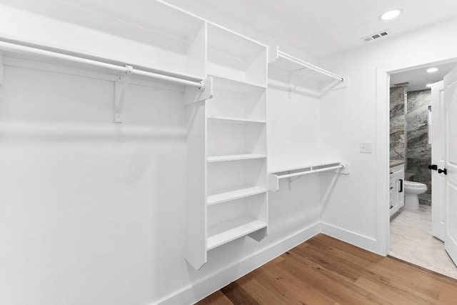 walk in closet featuring wood-type flooring