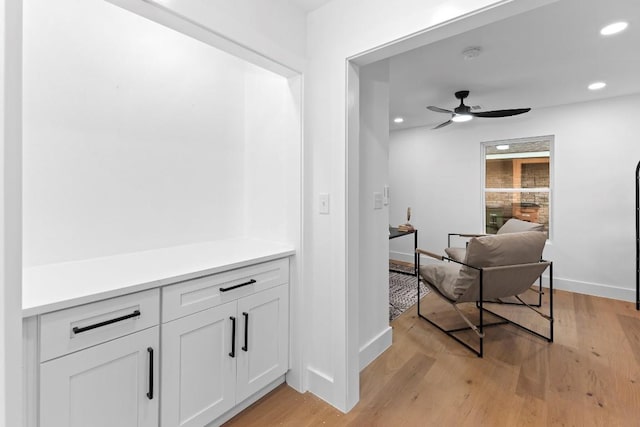 corridor with light hardwood / wood-style floors