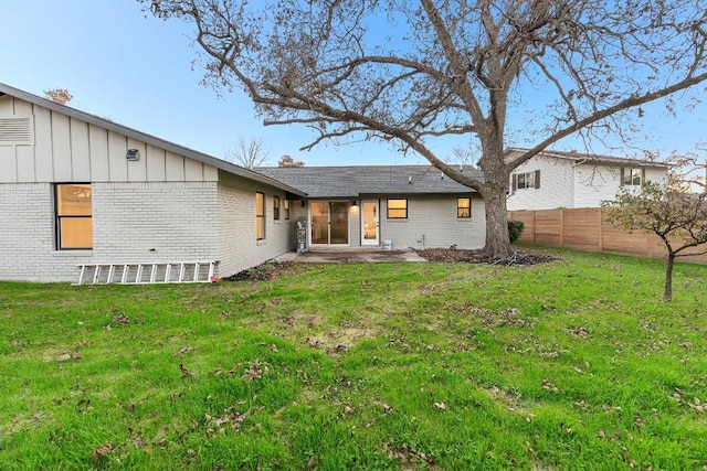 rear view of property with a patio area and a yard