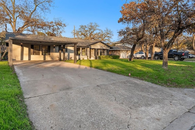 ranch-style house with a carport and a front lawn