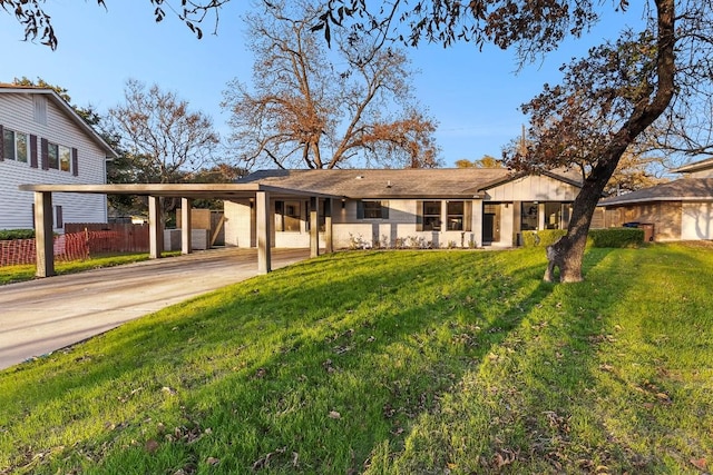 single story home with a front lawn and a carport