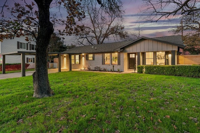 ranch-style home with a lawn