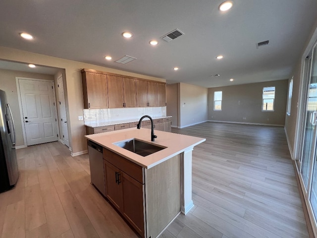 128 Alistair Dr, Georgetown, TX 78633 - kitchen with a sink, appliances with stainless steel finishes, an island with sink, baseboards, and light wood-type flooring