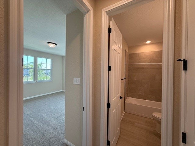 128 Alistair Dr, Georgetown, TX 78633 - bathroom with toilet, baseboards, and shower / tub combination