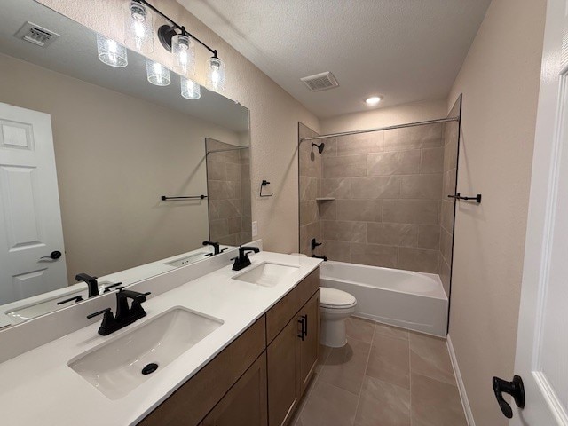 128 Alistair Dr, Georgetown, TX 78633 - full bath with toilet, double vanity, tile patterned floors, bathtub / shower combination, and a textured ceiling