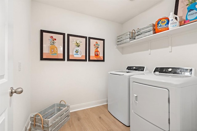 washroom with washer and dryer and light wood-type flooring