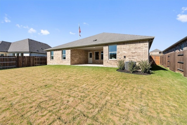 back of property featuring a lawn and a patio