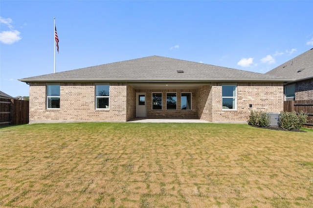 back of property featuring a lawn and a patio area