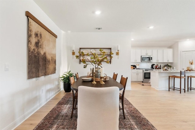 dining area with light hardwood / wood-style flooring