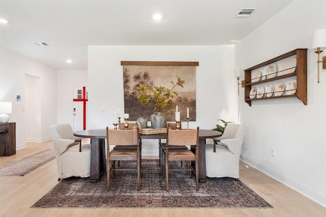 dining space with hardwood / wood-style floors