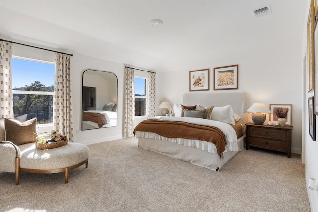 bedroom featuring light colored carpet