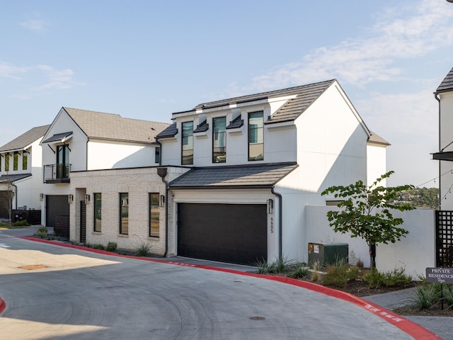 view of front of house featuring a garage and central air condition unit