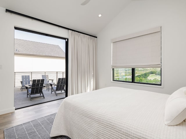 bedroom with access to exterior, lofted ceiling, and hardwood / wood-style flooring