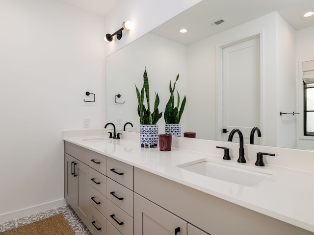 bathroom with tile patterned flooring and vanity