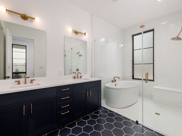 bathroom featuring tile patterned flooring, vanity, and shower with separate bathtub