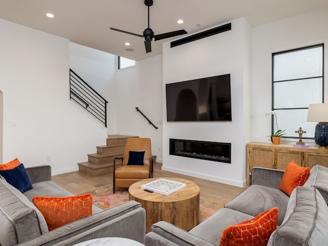 living room featuring ceiling fan and light wood-type flooring