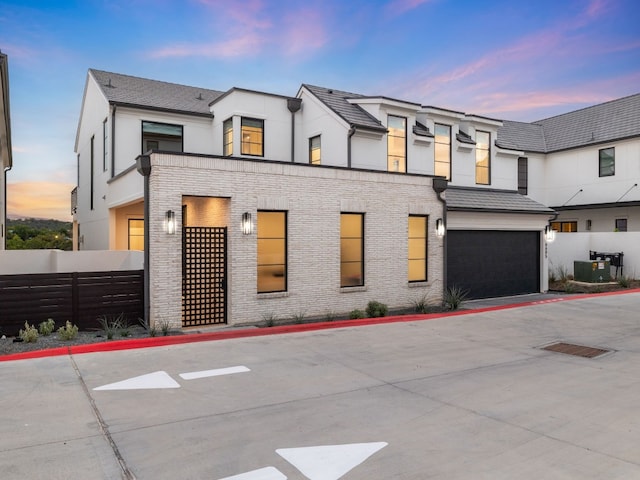 view of front of property featuring cooling unit and a garage