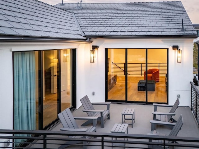 rear view of property with a balcony