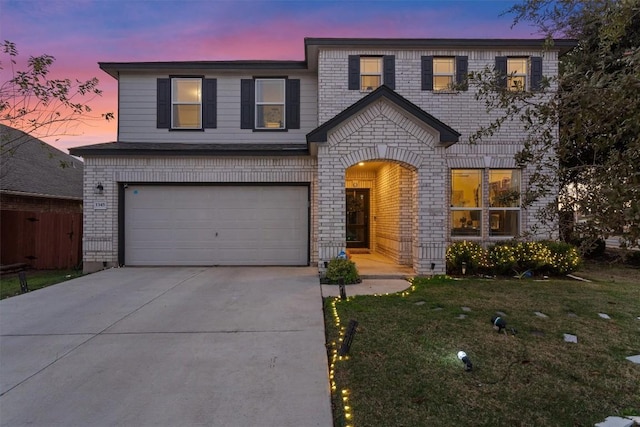 view of front of home featuring a yard and a garage