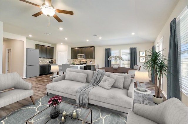 living room with hardwood / wood-style floors and ceiling fan