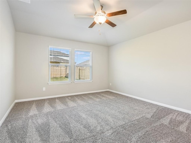 unfurnished room with ceiling fan and carpet