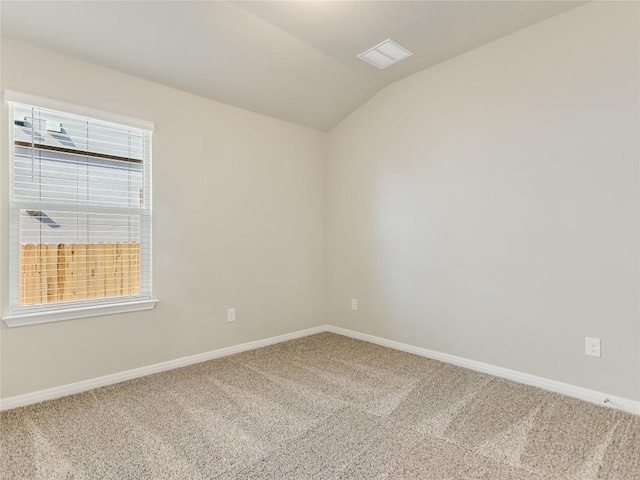 carpeted empty room with lofted ceiling