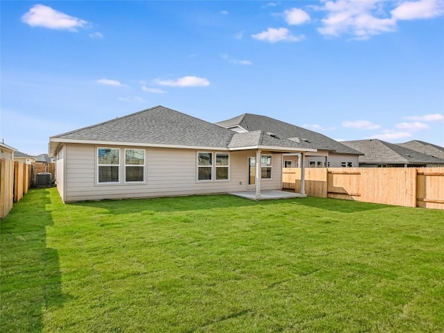 back of property with a yard, a patio, and central AC unit