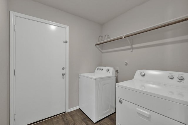 laundry area with washing machine and clothes dryer, laundry area, dark wood finished floors, and baseboards
