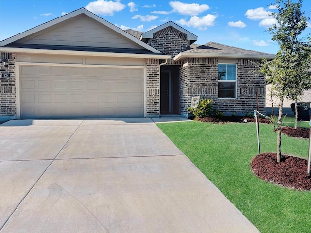 view of front of property with a garage, concrete driveway, a front lawn, and brick siding