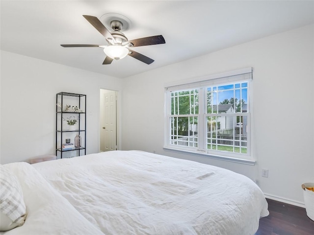 bedroom with ceiling fan and dark hardwood / wood-style flooring