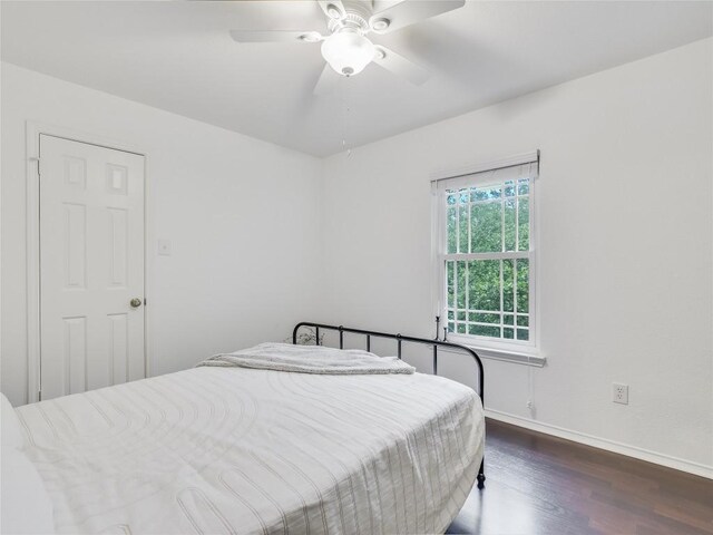 bedroom featuring ceiling fan and dark wood-type flooring