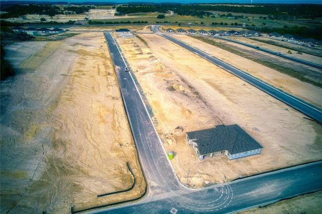 birds eye view of property with a rural view