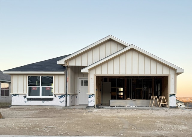 view of front facade featuring an outbuilding and a garage