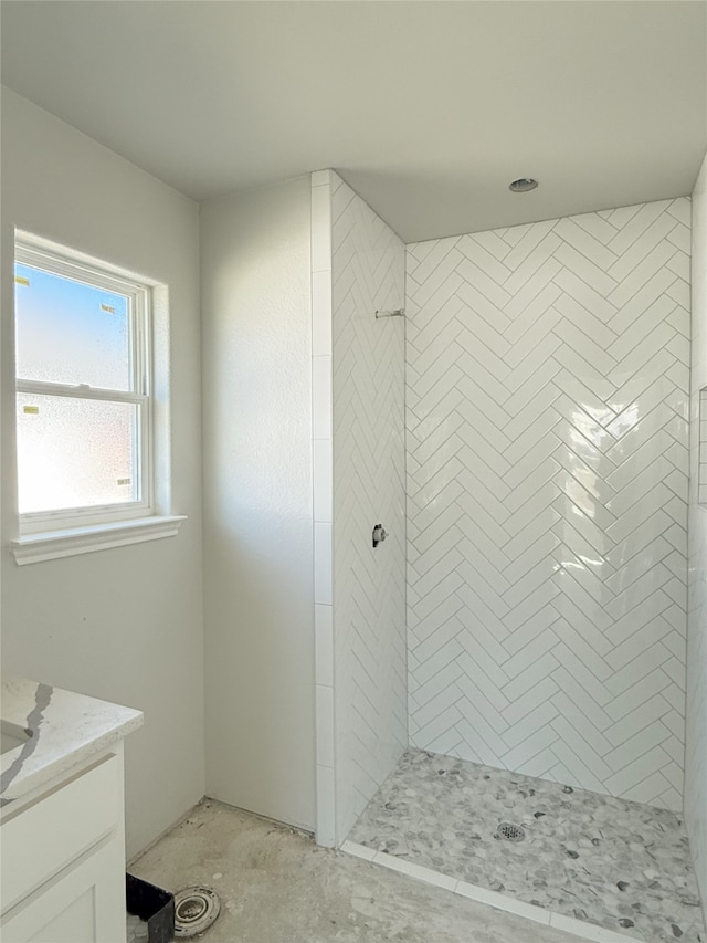 bathroom featuring vanity and tiled shower