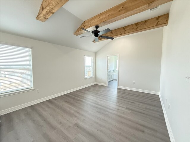 unfurnished room featuring a ceiling fan, baseboards, vaulted ceiling with beams, wood finished floors, and visible vents